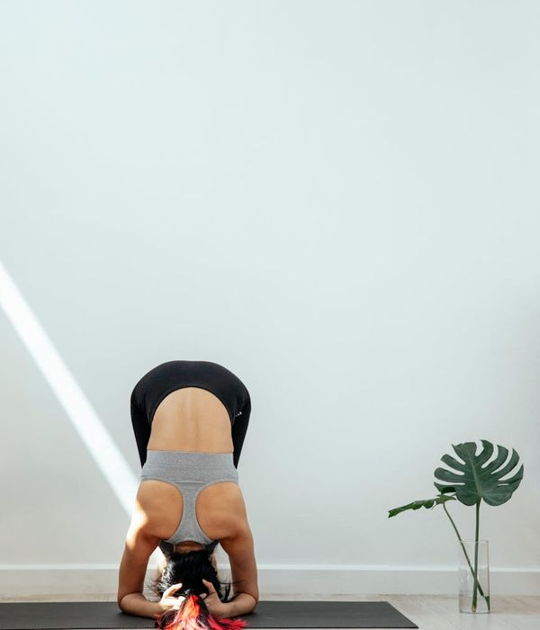 Woman in a calm yoga pose in a bright, serene studio.
